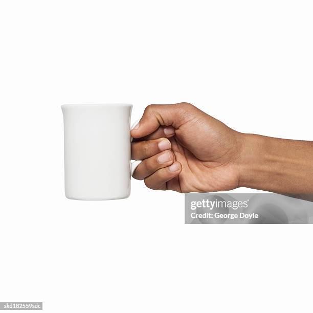 close-up of male hand holding mug - coffee cup isolated stock pictures, royalty-free photos & images