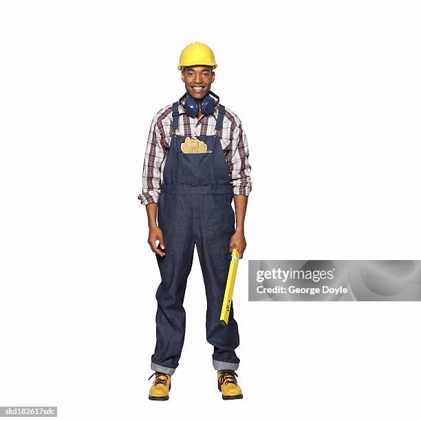 portrait of a man wearing hard hat and holding a spirit level - hard hat white background ストックフォトと画像