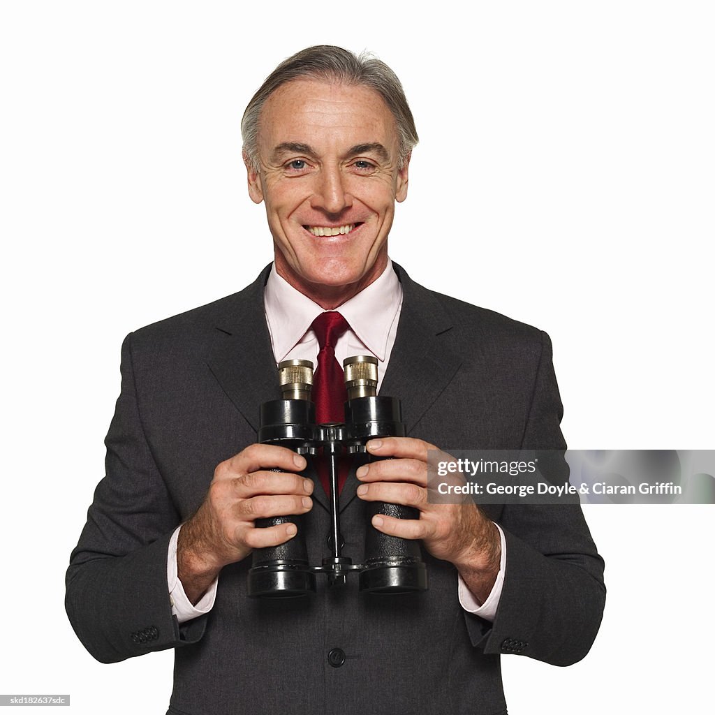 Close-up of businessman holding binoculars