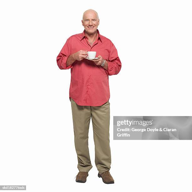 front view portrait of mature man holding cup and saucer - pires imagens e fotografias de stock