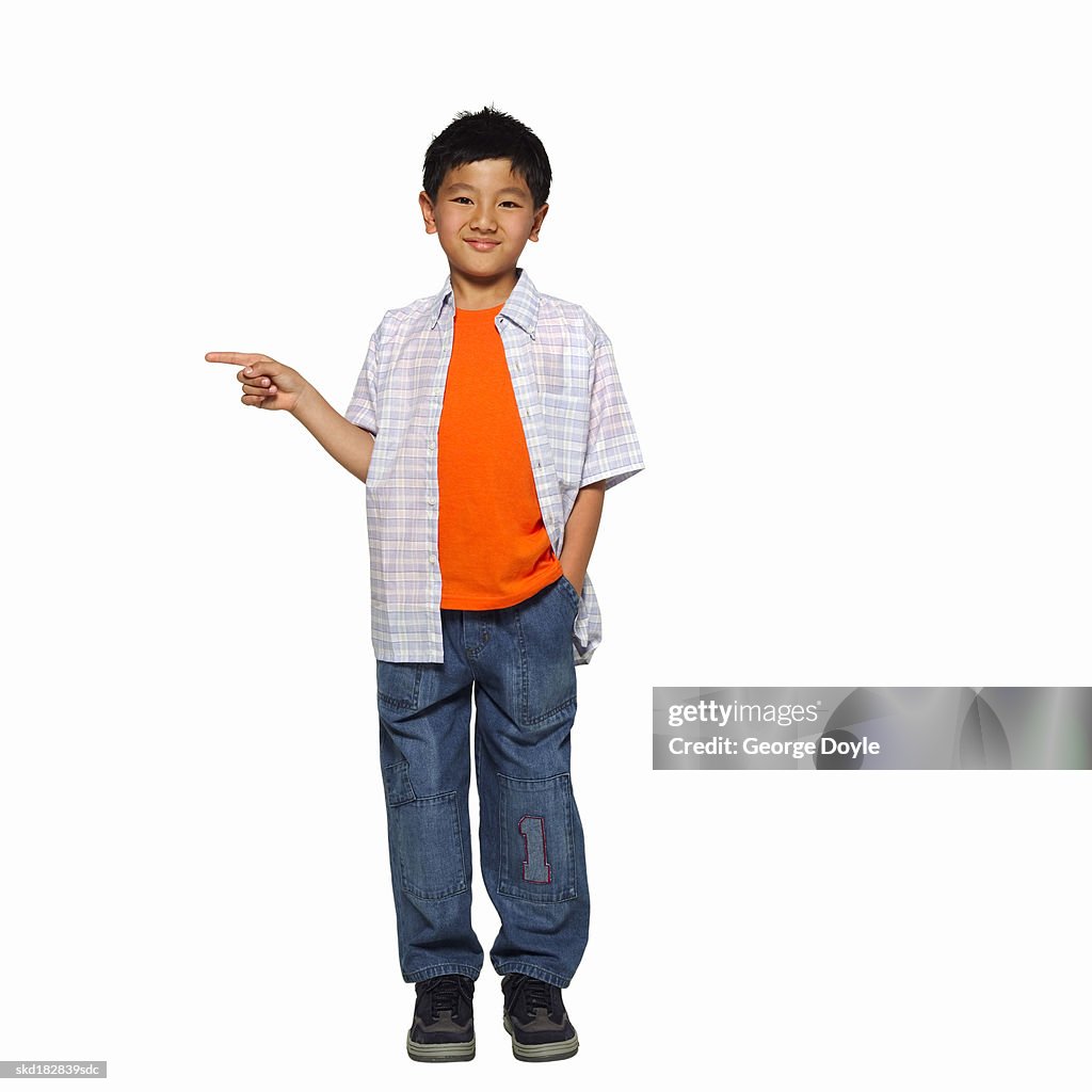 Front view portrait of a boy (10-11) pointing his finger