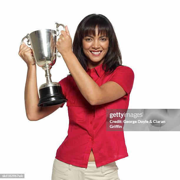 portrait of a woman holding a trophy - trophy stand stock pictures, royalty-free photos & images