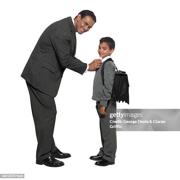 portrait of a father fixing his son's (10-11) school uniform - school uniform ストックフォトと画像