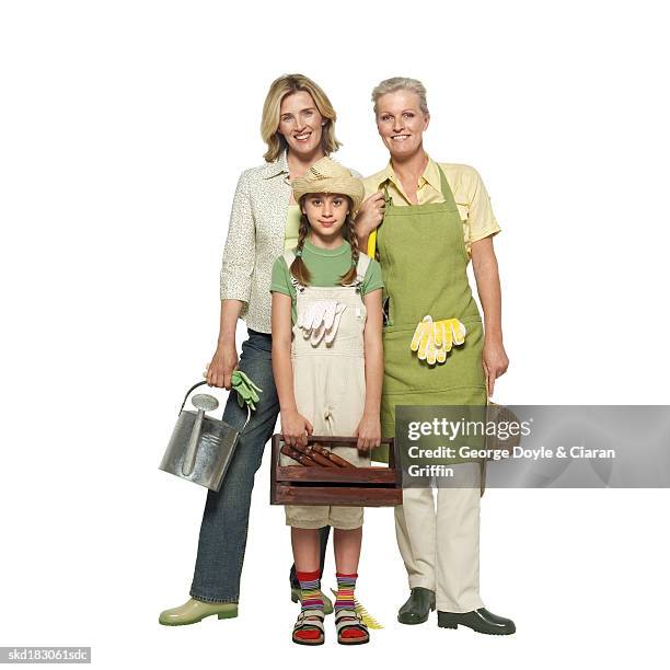 front view portrait of a three generation family (10-11) holding watering can and gardening kit - pour spout stock pictures, royalty-free photos & images