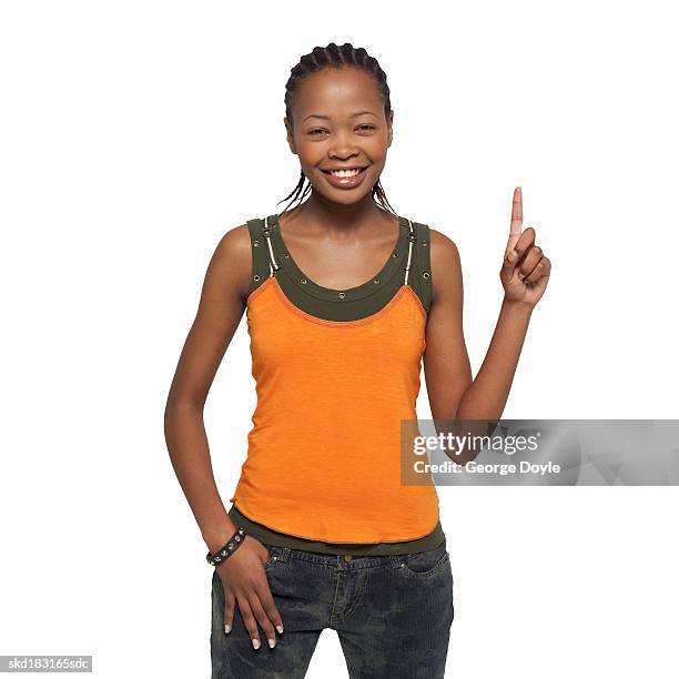 portrait of a woman holding a finger up - hand opsteken stockfoto's en -beelden