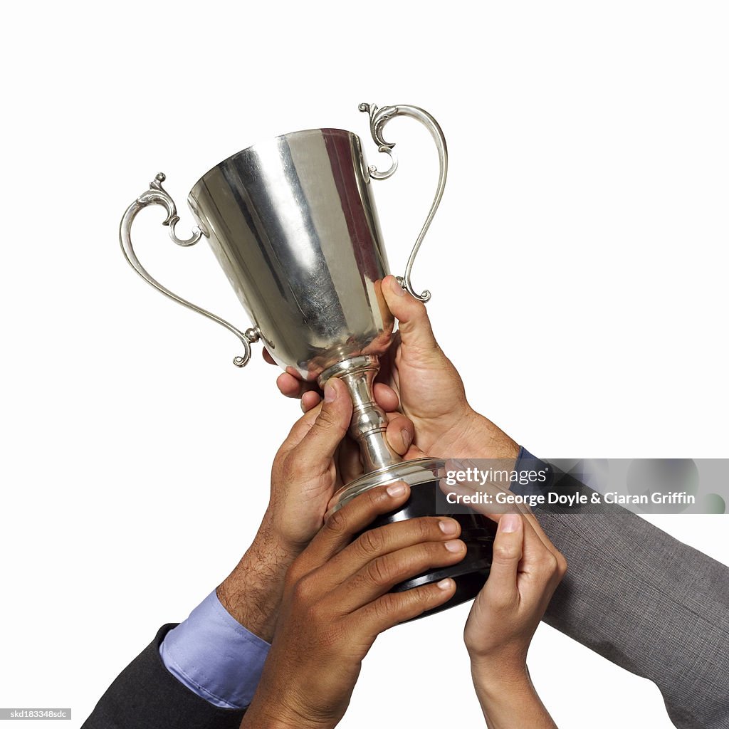 Close up view of hands holding a trophy