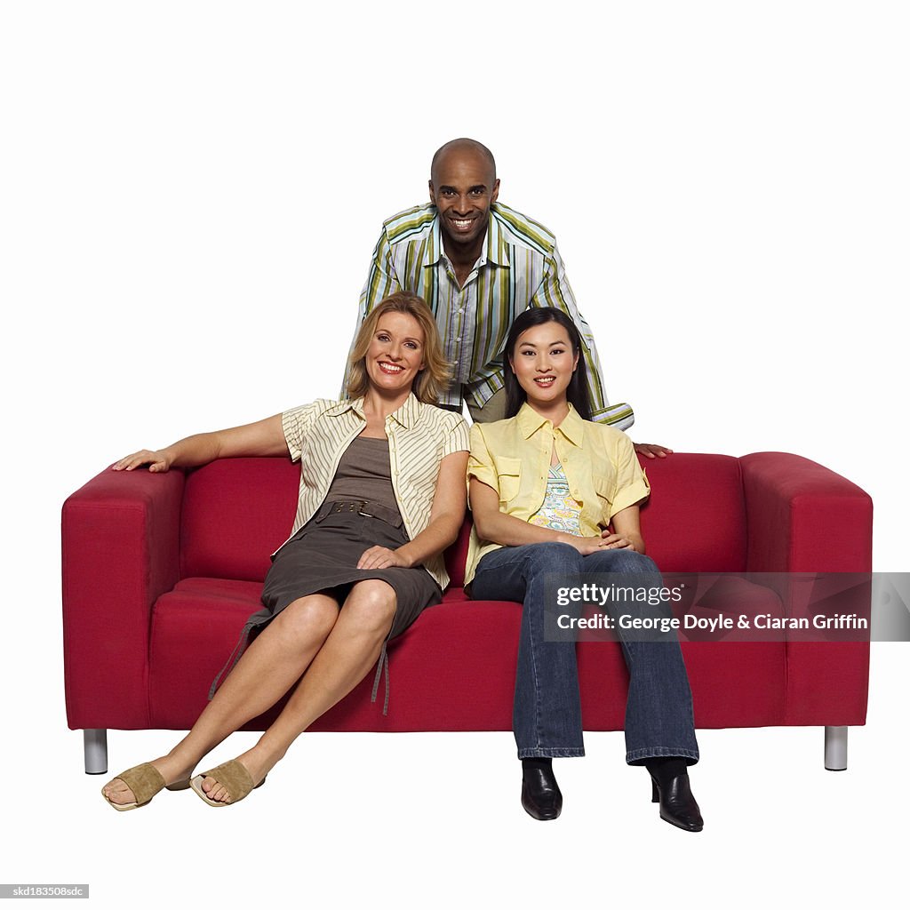 Portrait of three friends relaxing on a sofa