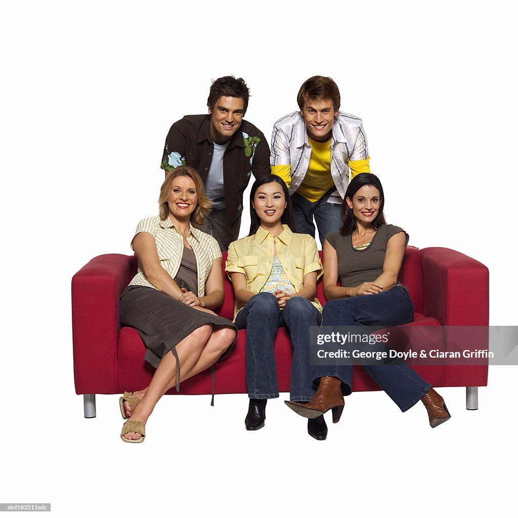 Portrait of five friends relaxing on a sofa
