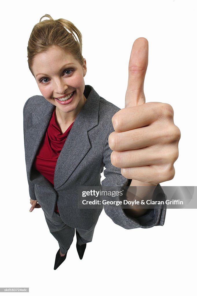 Elevated view of young businesswoman giving thumbs up