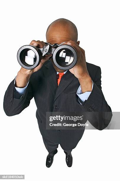 elevated portrait of a businessman looking through binoculars - binocular with man stock pictures, royalty-free photos & images