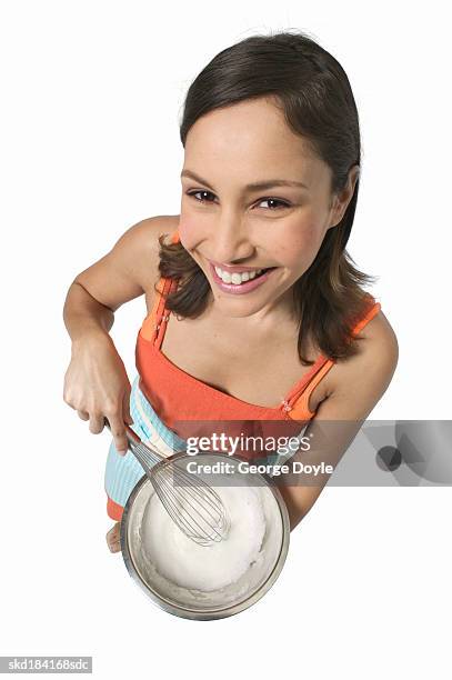 high angle view of a woman stirring mixture in a bowl - female whipping 個照片及圖片檔