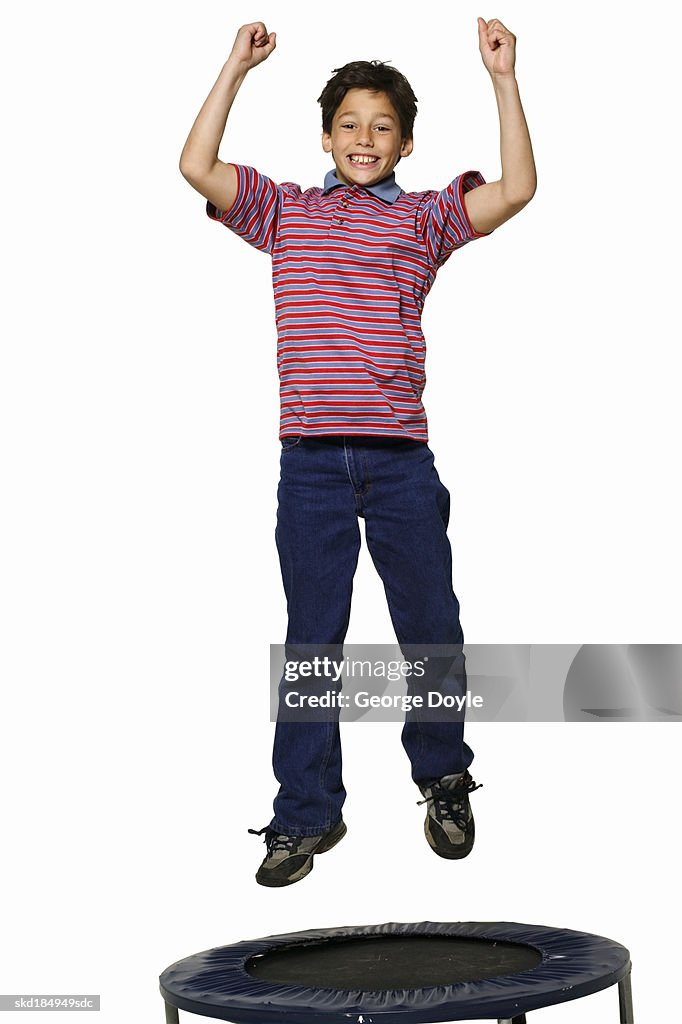 Elevated view of a boy (11-12) jumping on trampoline