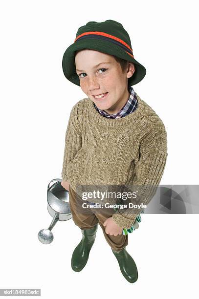 elevated view of a boy (11-12) holding a watering can - pour spout stock pictures, royalty-free photos & images