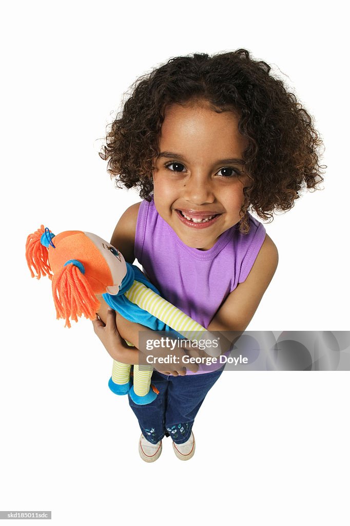 Elevated view of a girl (8-9) holding teddy bear