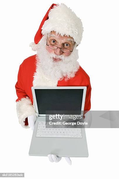 elevated view of santa claus holding laptop - silver surfer stock pictures, royalty-free photos & images