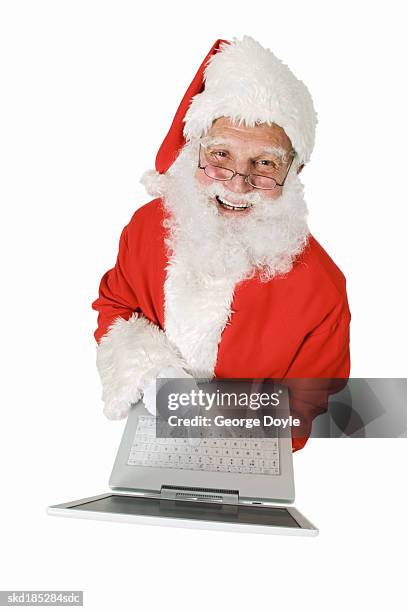 elevated view of santa holding laptop - silver surfer stock pictures, royalty-free photos & images