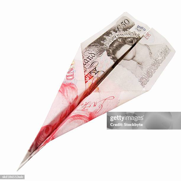 close up of a 50 pound note sterling folded into a plane - 50 pound notes stock pictures, royalty-free photos & images