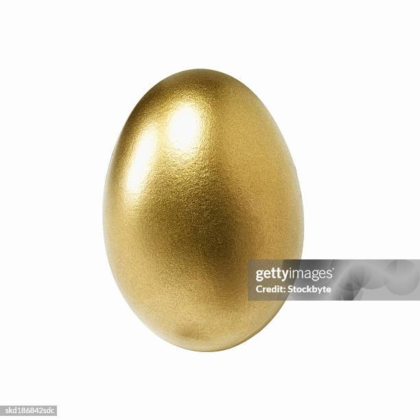 close up of a golden egg - egg ストックフォトと画像