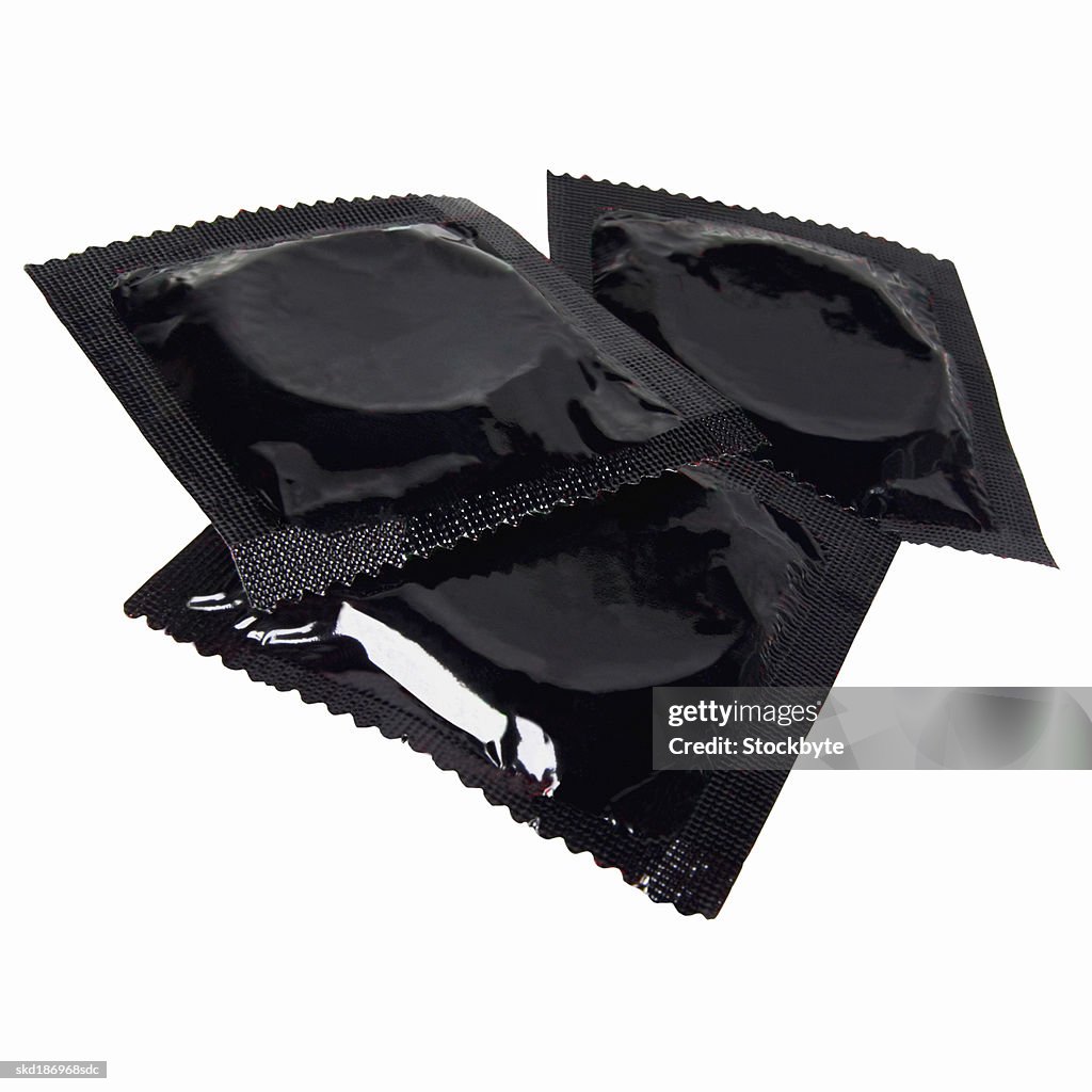 Close up of three condoms in packets