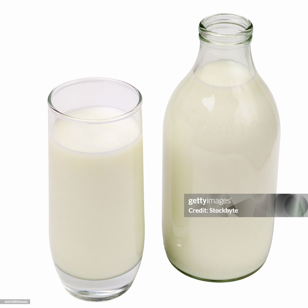 Close up of a glass of milk and a bottle of milk