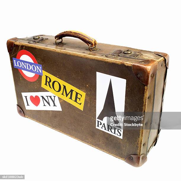 close up of a suitcase covered with travel stickers - suitcase close stock-fotos und bilder