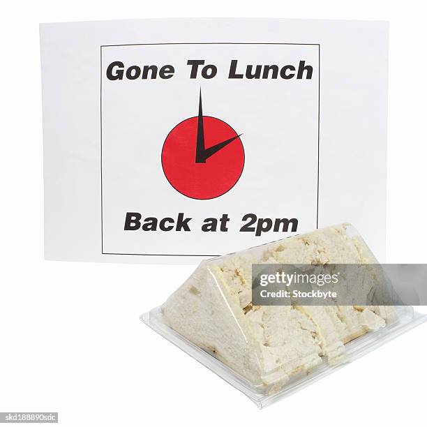 close-up of a gone to lunch sign and a packaged sandwich - gone to lunch stock pictures, royalty-free photos & images