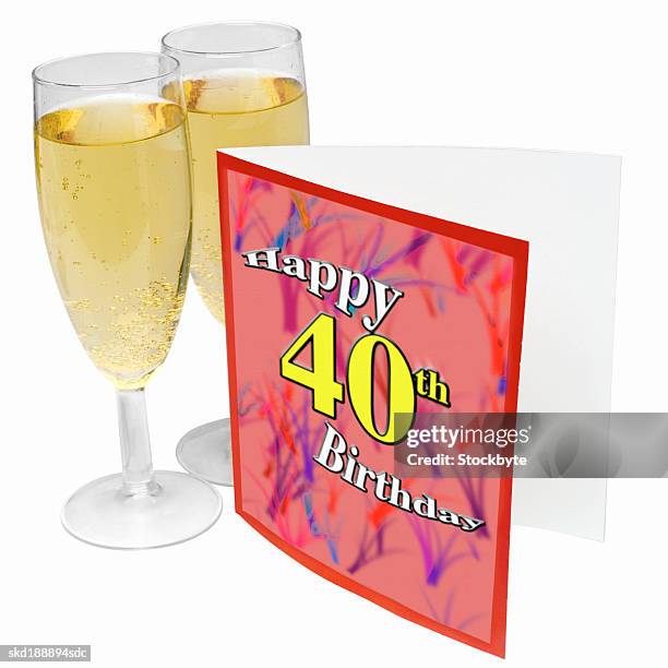 close-up of a 40th birthday card and two glasses of champagne - 40th birthday stock pictures, royalty-free photos & images