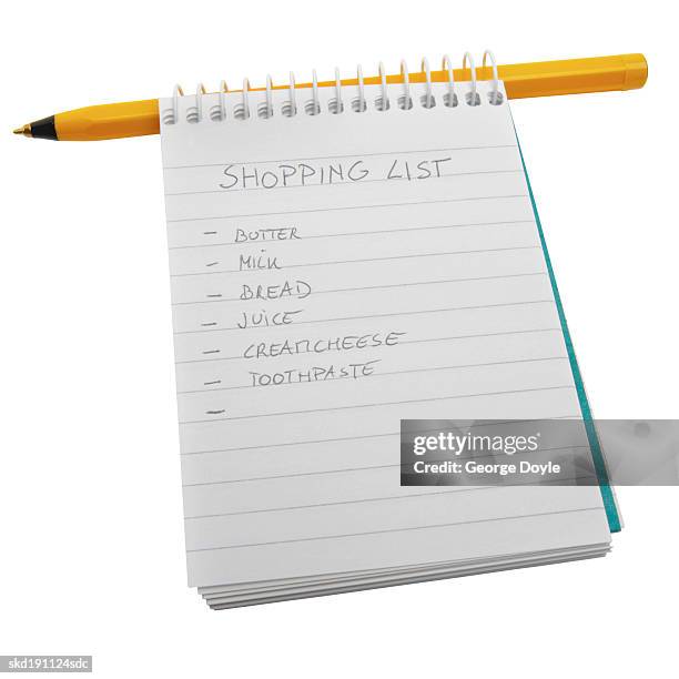 close up of a shopping list written on a notepad - shopping list stock pictures, royalty-free photos & images