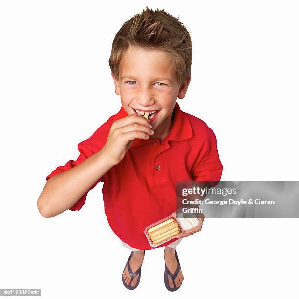 elevated view of a boy (10-11) holding a cheese dip and sticks - cheese-sticks-isolated stock pictures, royalty-free photos & images