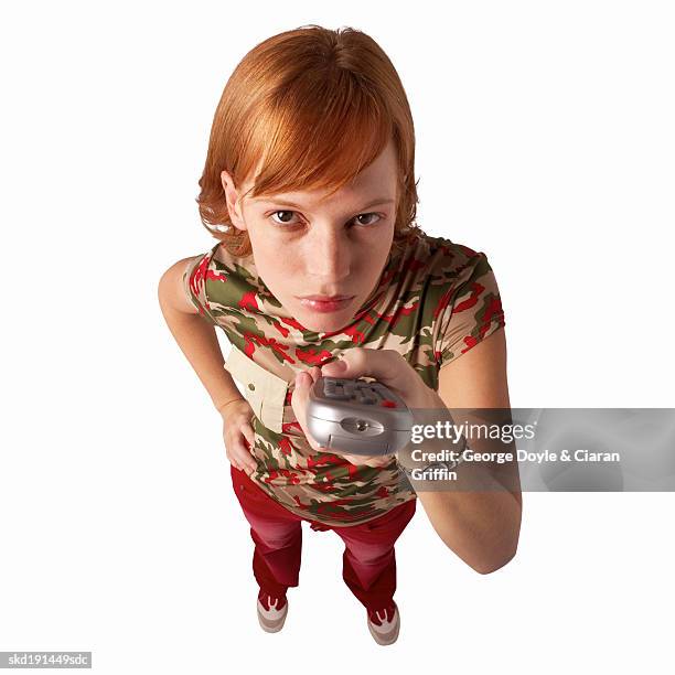 elevated view of a woman holding a remote control - control photos et images de collection