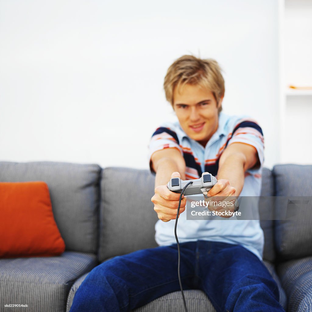 Front view of young man playing computer game