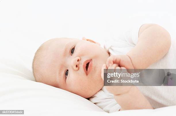 close-up of baby girl lying down (6-12 months) - only baby girls stock pictures, royalty-free photos & images