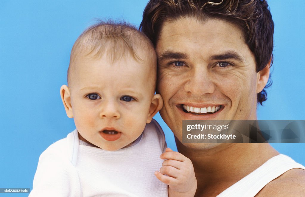 Front view portrait of father holding baby boy (6-12 months)