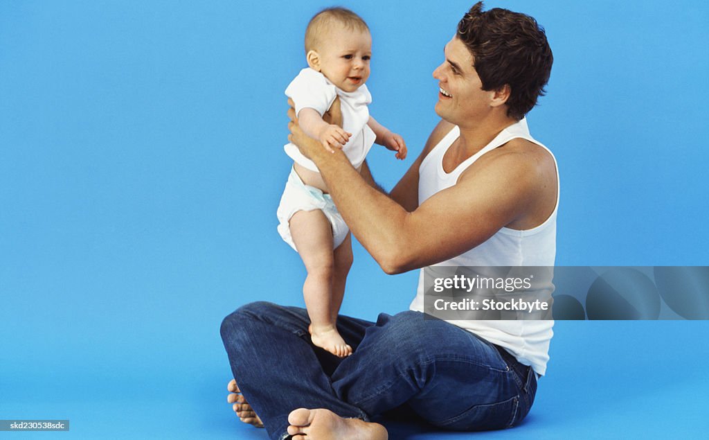 Close-up of father holding baby boy (6-12 months)