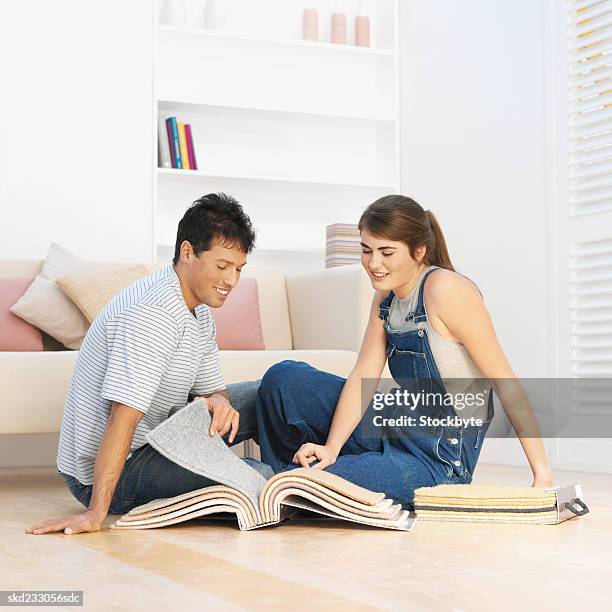 couple looking at carpet samples - medical sample stock-fotos und bilder