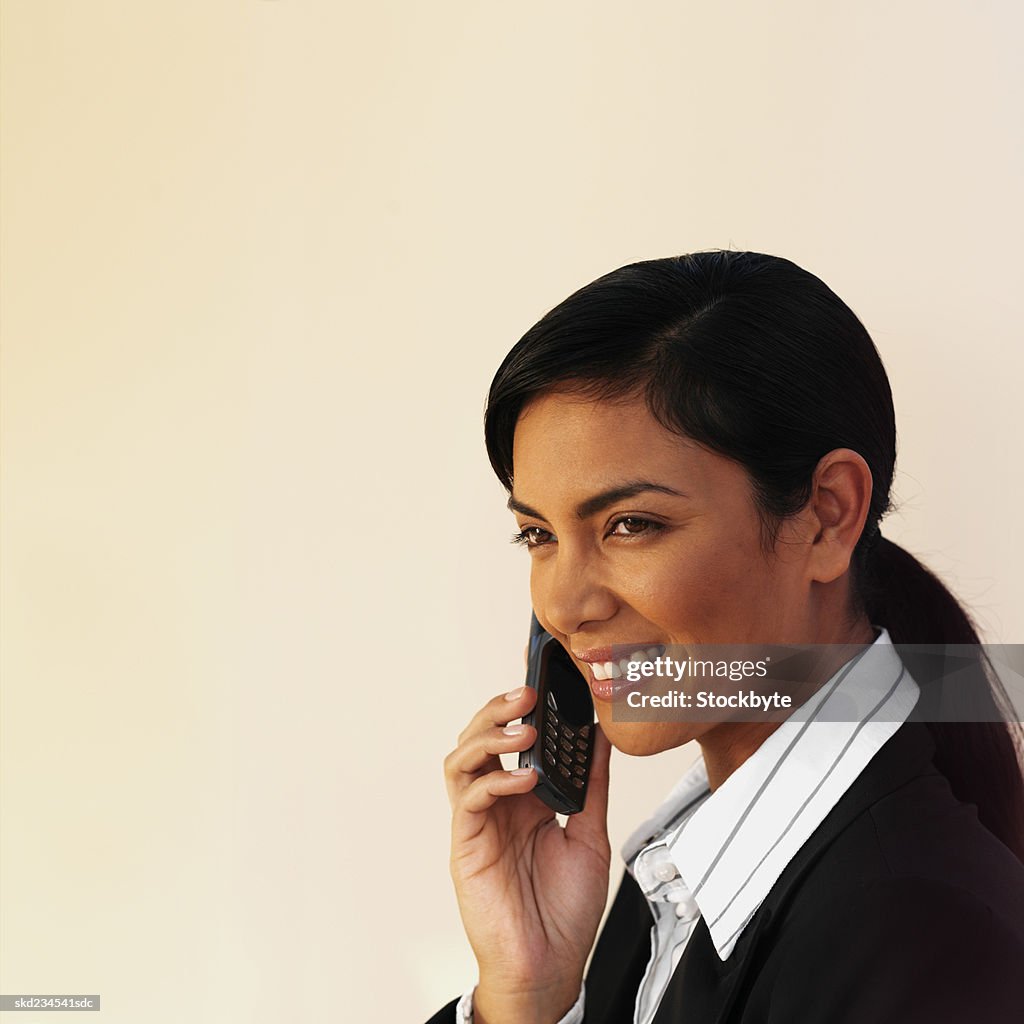Side view of a happy businesswoman using a mobile phone
