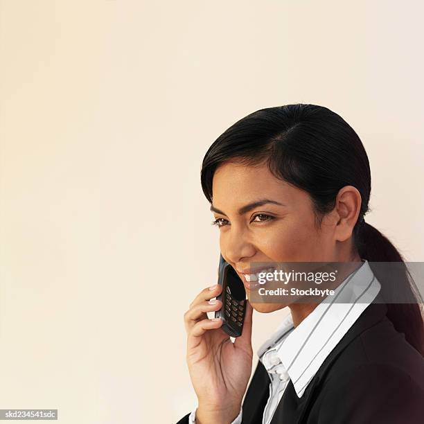 side view of a happy businesswoman using a mobile phone - happy mobile stockfoto's en -beelden