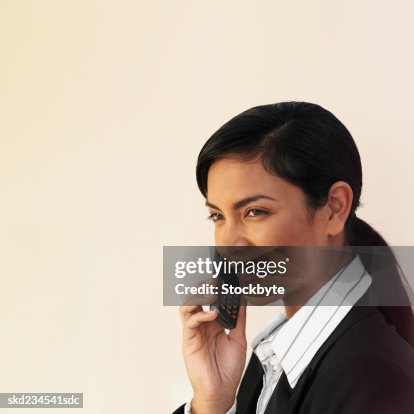 Side view of a happy businesswoman using a mobile phone Side view of a happy businesswoman using a mobile phone