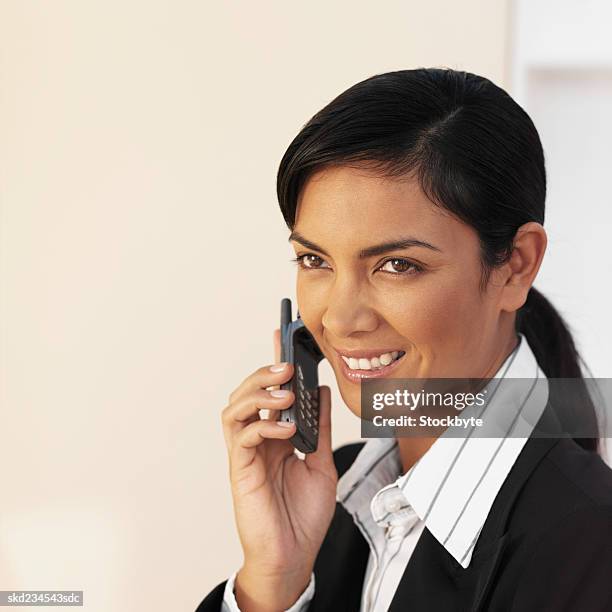 side view close-up of a happy businesswoman using a mobile phone - happy mobile stockfoto's en -beelden