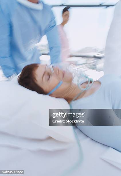 side profile of a woman being wheeled into surgery - patient profile stock pictures, royalty-free photos & images