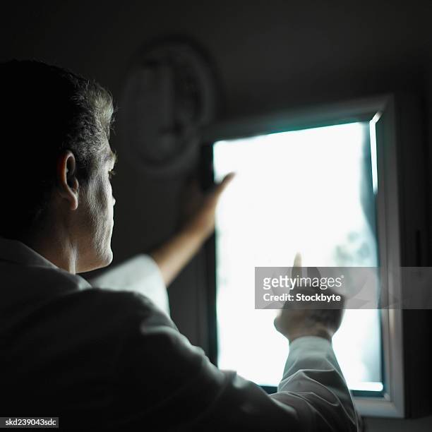 close-up of a mature doctor examining e-ray - pharrell williams of n e r d sighting in new york ctiy stockfoto's en -beelden