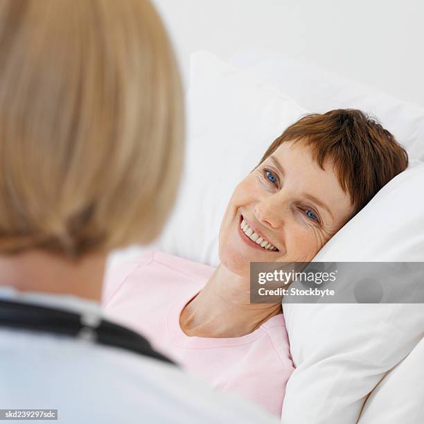 close-up of doctor talking to mature patient - rapporto medico paziente foto e immagini stock