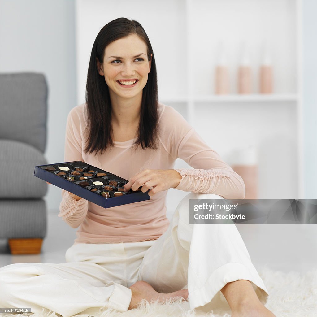 Woman enjoying a box of chocolates