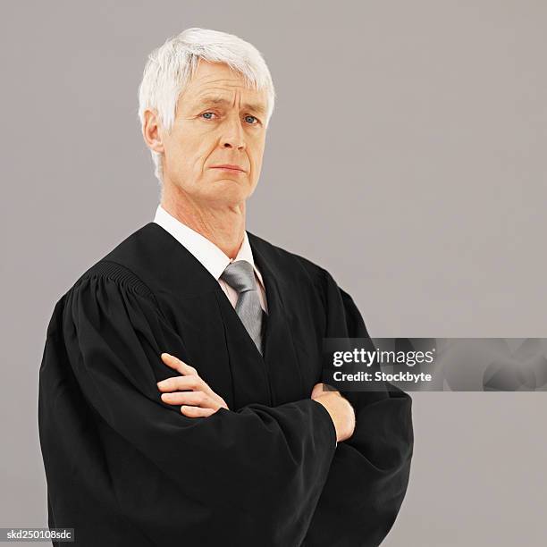 front view portrait of male judge with arms crossed - ornaat stock-fotos und bilder