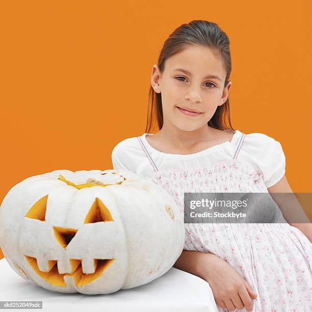 girl (8-9) and halloween pumpkin - girl in orange dress stock pictures, royalty-free photos & images