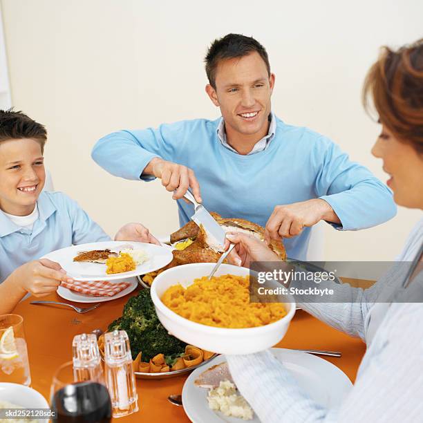 family having dinner together - carving set stock pictures, royalty-free photos & images