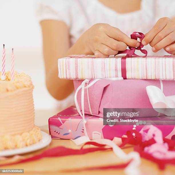 girl (9-10) opening up with presents - opening celebration of gregory colberts ashes and snow exhibition arrivals stockfoto's en -beelden