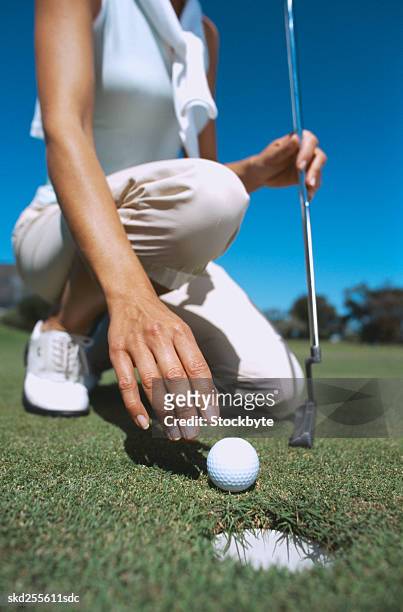 close-up of a golf ball and club in a young woman's hands - golf club - fotografias e filmes do acervo