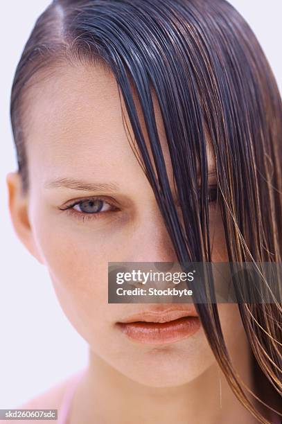 close-up of a young woman's face with wet hair falling across it - across stock pictures, royalty-free photos & images