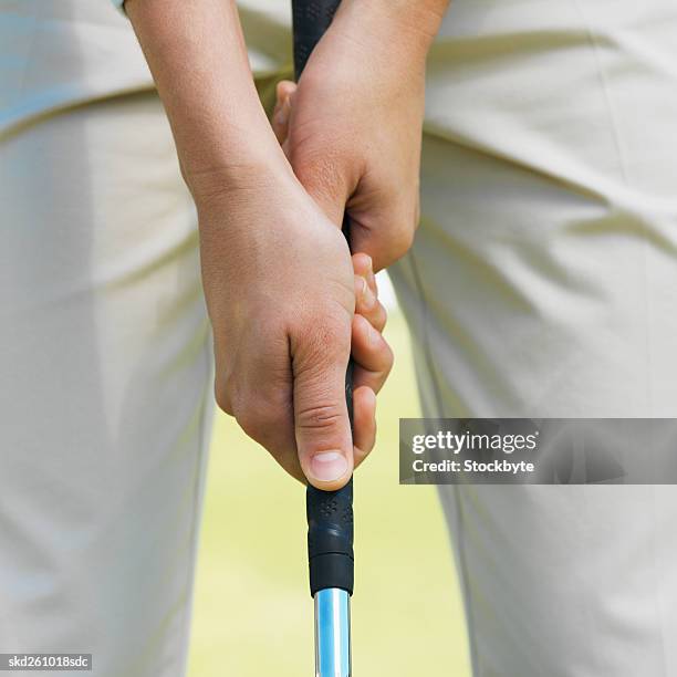 mid section of a golfer about to take a shot - about stock pictures, royalty-free photos & images